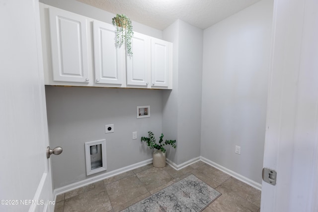 clothes washing area with hookup for a washing machine, cabinets, a textured ceiling, and hookup for an electric dryer