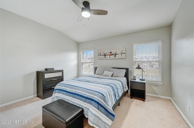 carpeted bedroom with ceiling fan, lofted ceiling, and multiple windows