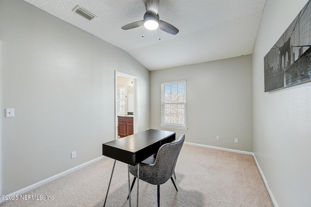 carpeted home office with a textured ceiling, ceiling fan, and lofted ceiling