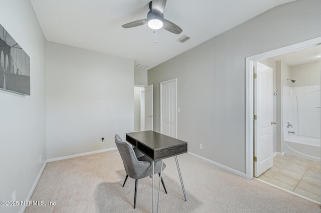 carpeted office space with ceiling fan