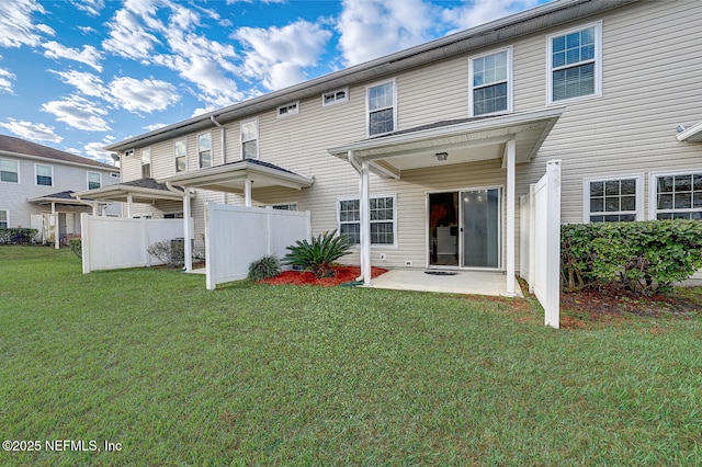 rear view of property featuring a yard