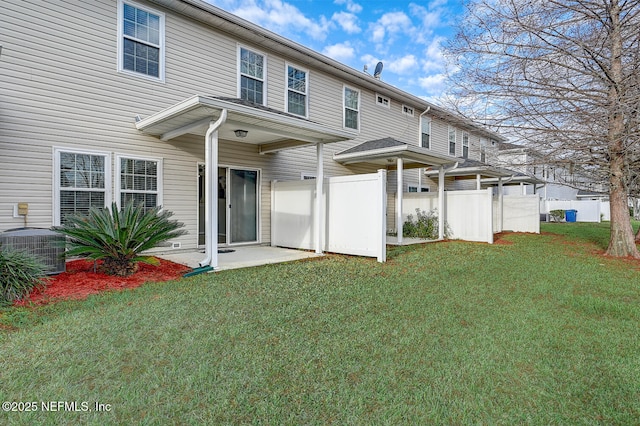 back of property featuring a yard and central AC