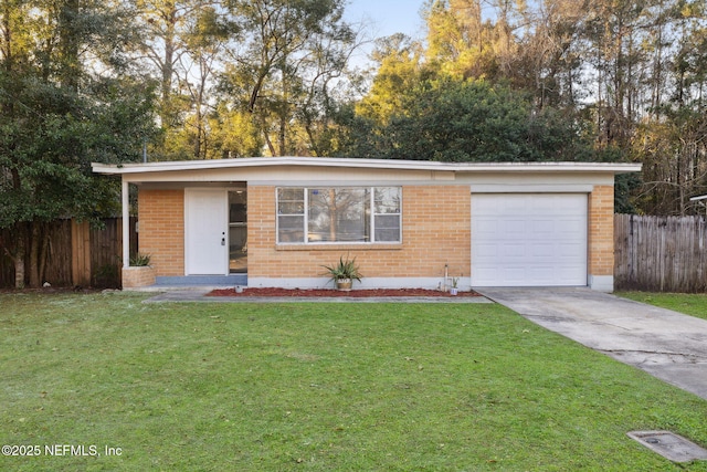 view of front of house featuring driveway, brick siding, a front yard, and fence