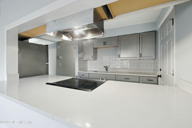 kitchen featuring light countertops, a sink, and freestanding refrigerator