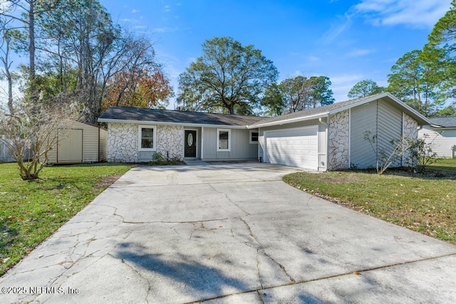 single story home featuring a front lawn, a garage, and a storage shed