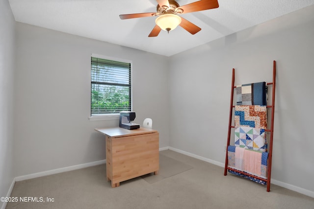 interior space featuring light colored carpet and ceiling fan