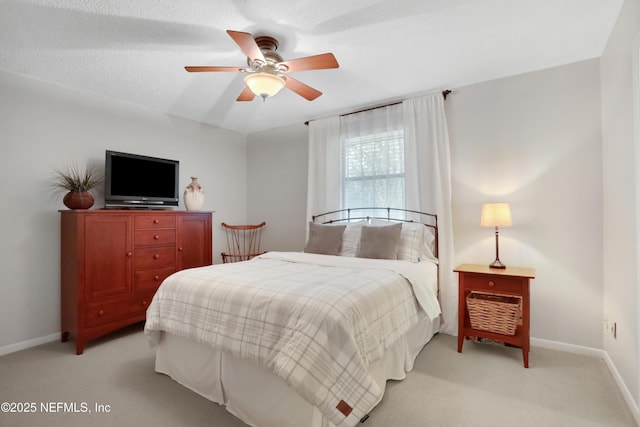 bedroom with light carpet, a textured ceiling, and ceiling fan