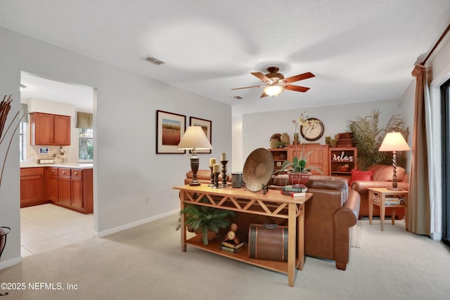 living room featuring light colored carpet and ceiling fan