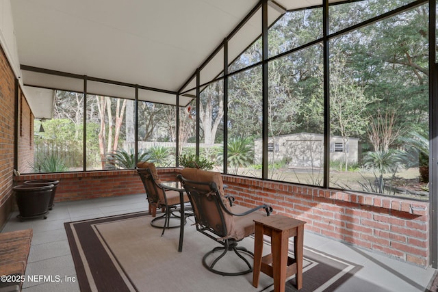 sunroom featuring vaulted ceiling