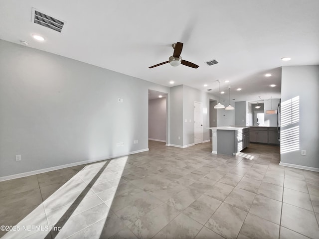 unfurnished living room with ceiling fan and light tile patterned floors