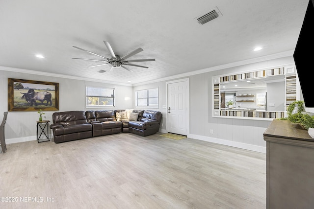 living room with ceiling fan, light wood-type flooring, and ornamental molding