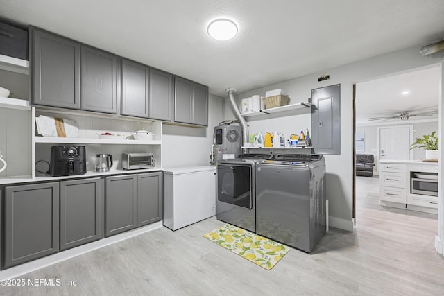 laundry area with washer and clothes dryer, ceiling fan, and light wood-type flooring