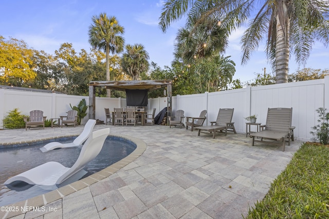 view of patio with a fenced in pool and an outdoor bar