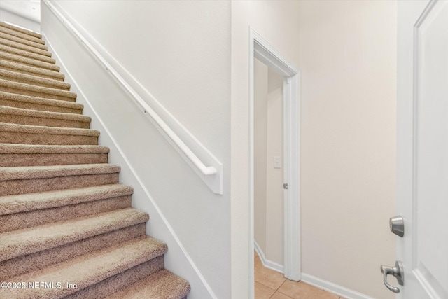 staircase with tile patterned floors