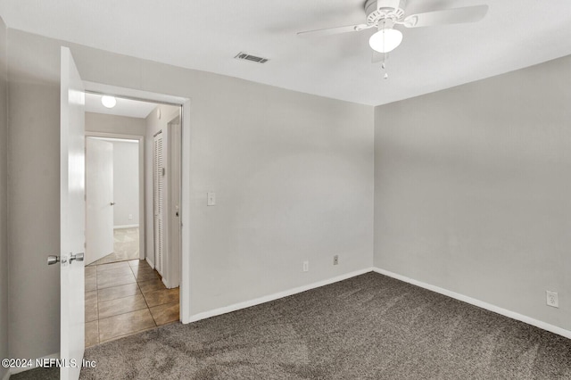 empty room with ceiling fan and carpet floors