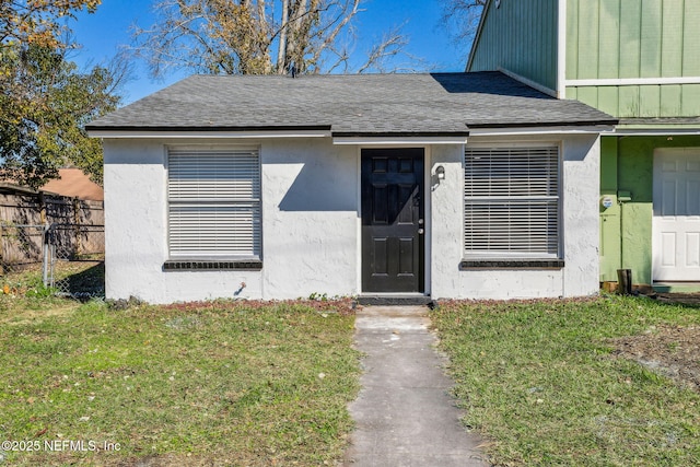 doorway to property with a yard