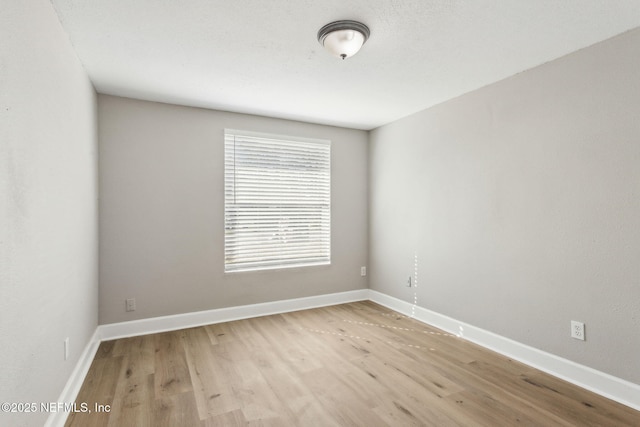 spare room with light hardwood / wood-style flooring