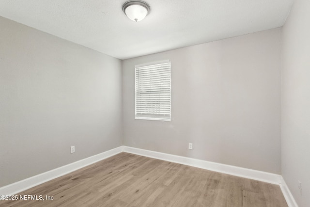 spare room with light wood-type flooring