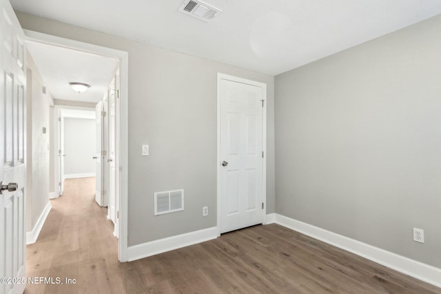 spare room with wood-type flooring