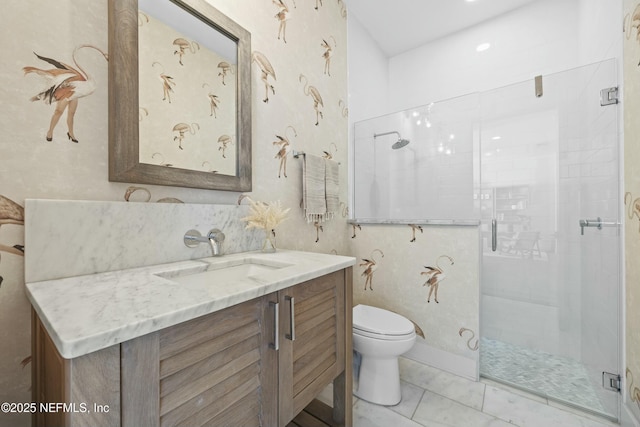 bathroom featuring vanity, an enclosed shower, and toilet