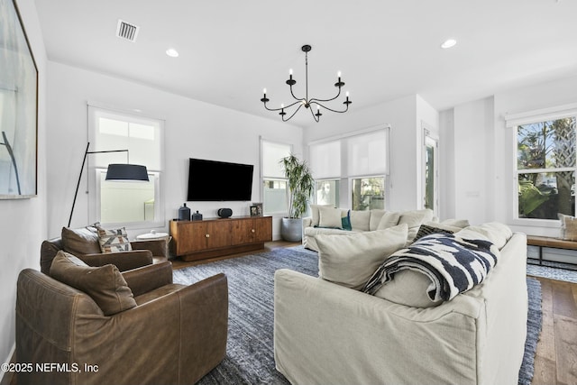 living room with dark hardwood / wood-style flooring and a chandelier