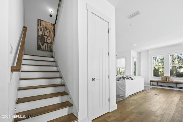 stairway with hardwood / wood-style flooring