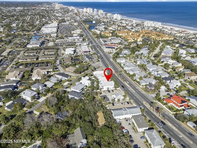 birds eye view of property featuring a water view and a view of the beach