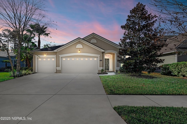 view of front of property with a lawn and a garage