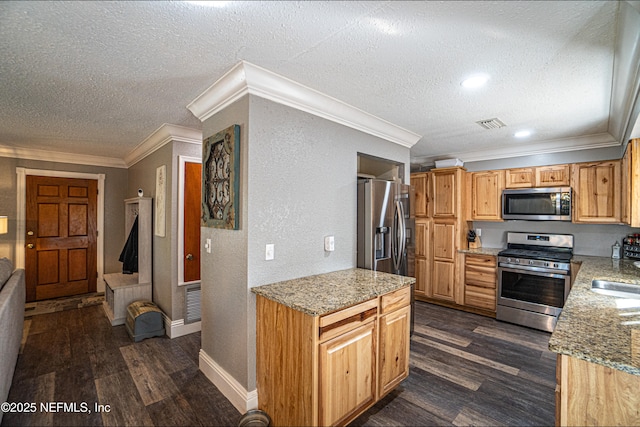 kitchen with a textured ceiling, dark hardwood / wood-style floors, light stone countertops, and stainless steel appliances