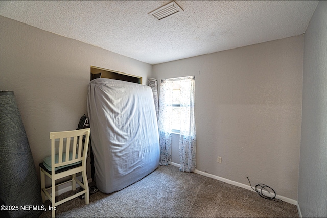 unfurnished bedroom with carpet and a textured ceiling