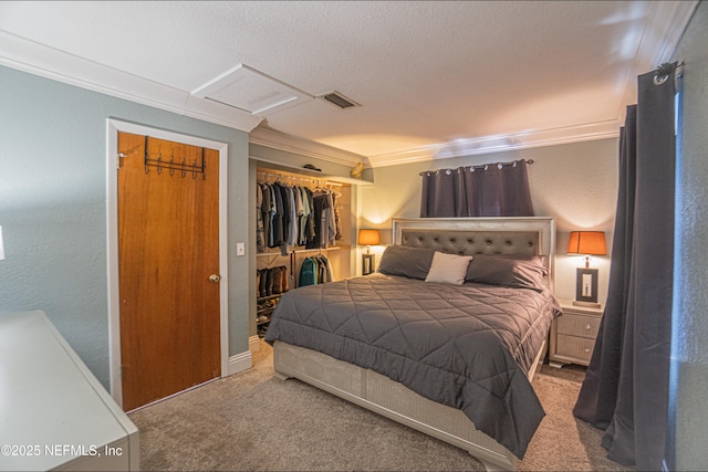 carpeted bedroom featuring crown molding and a closet