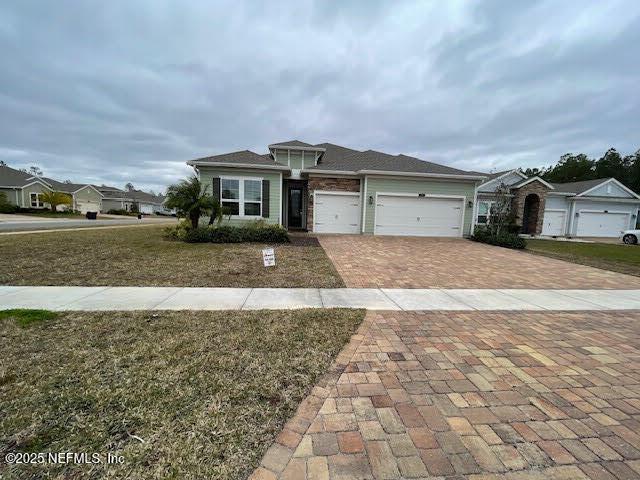 view of front facade with a front yard and a garage