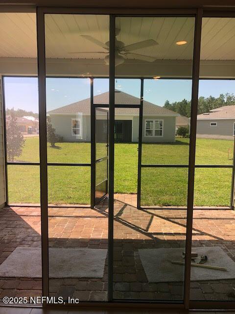 doorway featuring ceiling fan