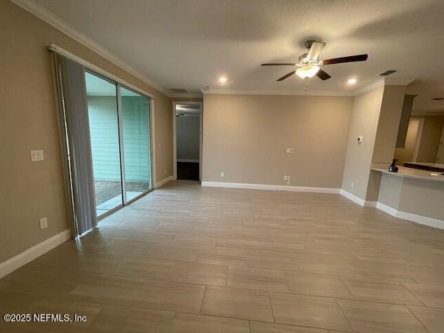 spare room featuring ceiling fan, a healthy amount of sunlight, and crown molding