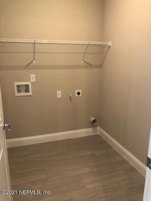 laundry area with electric dryer hookup, dark hardwood / wood-style flooring, and hookup for a washing machine