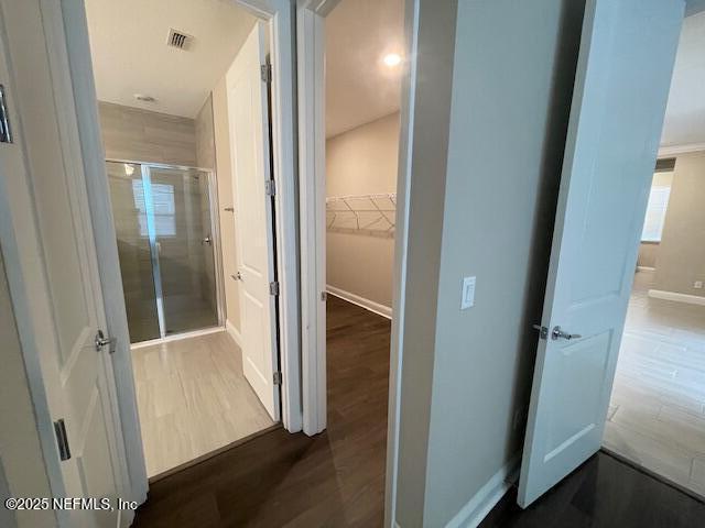 corridor featuring dark hardwood / wood-style flooring