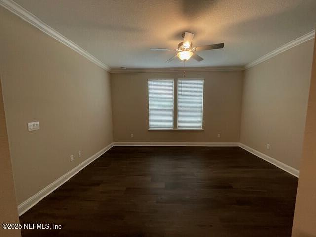 spare room featuring a textured ceiling, dark hardwood / wood-style flooring, ceiling fan, and crown molding