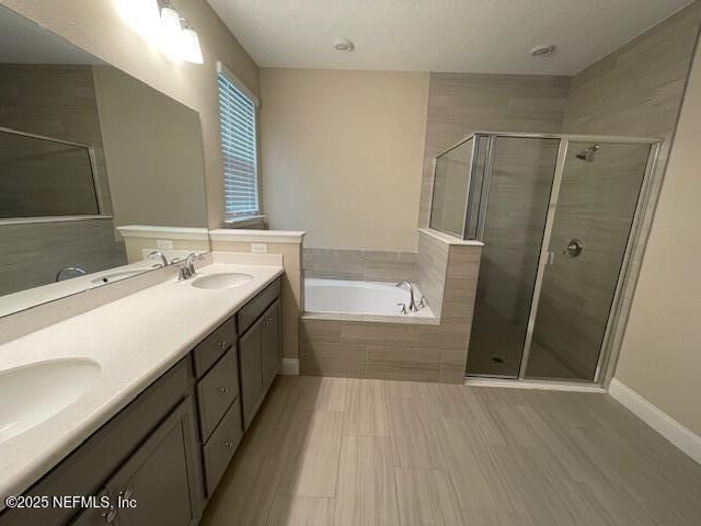 bathroom featuring separate shower and tub and vanity