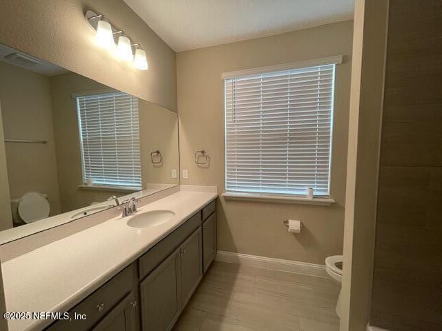 bathroom featuring vanity and toilet