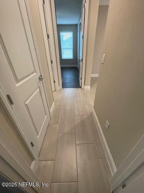 hallway with light hardwood / wood-style flooring