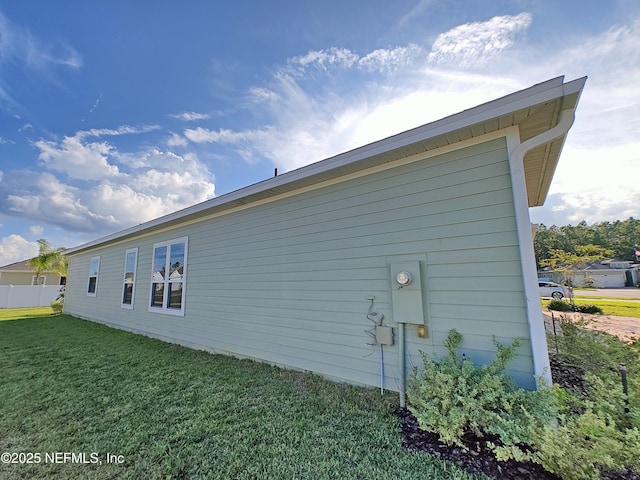 view of home's exterior with a lawn