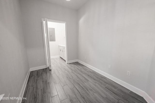 spare room featuring light hardwood / wood-style floors and electric panel