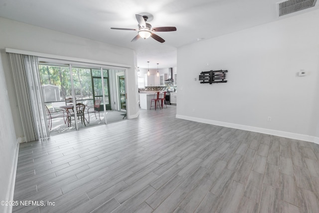 empty room featuring ceiling fan and light hardwood / wood-style flooring