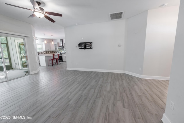 spare room featuring ceiling fan and light hardwood / wood-style floors