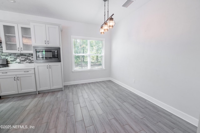 unfurnished dining area with light hardwood / wood-style floors