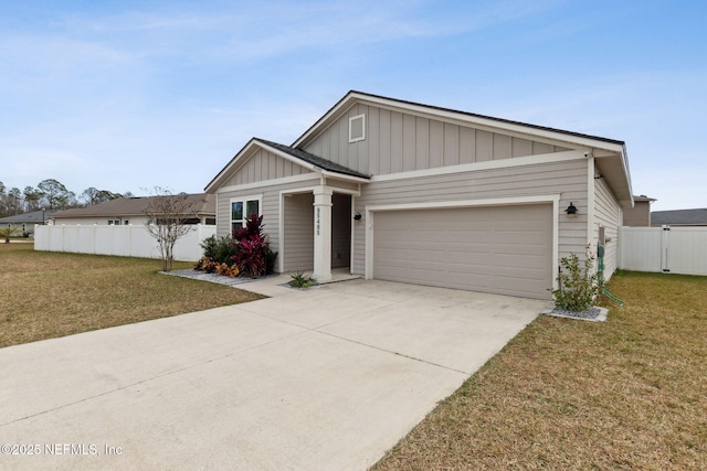 view of front of home with a front yard and a garage