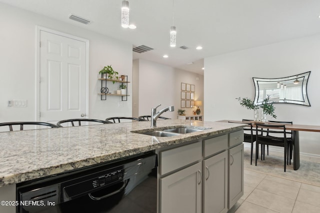 kitchen featuring gray cabinetry, sink, black dishwasher, light tile patterned flooring, and light stone counters