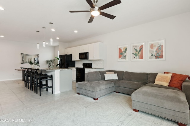 tiled living room featuring ceiling fan