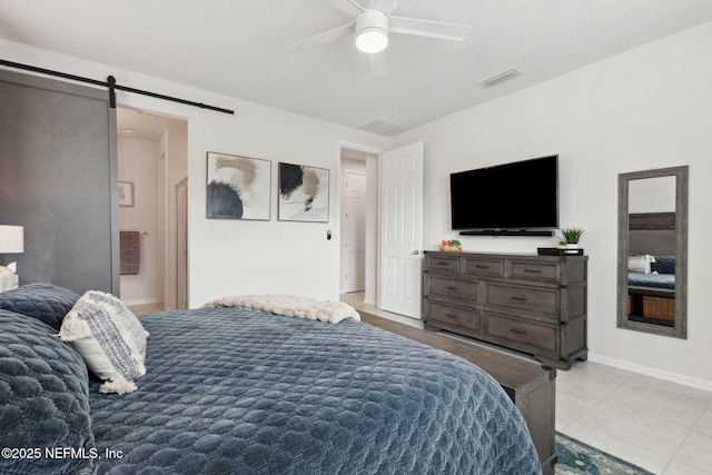 tiled bedroom with a barn door and ceiling fan