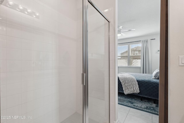 bathroom with ceiling fan, tile patterned flooring, and an enclosed shower